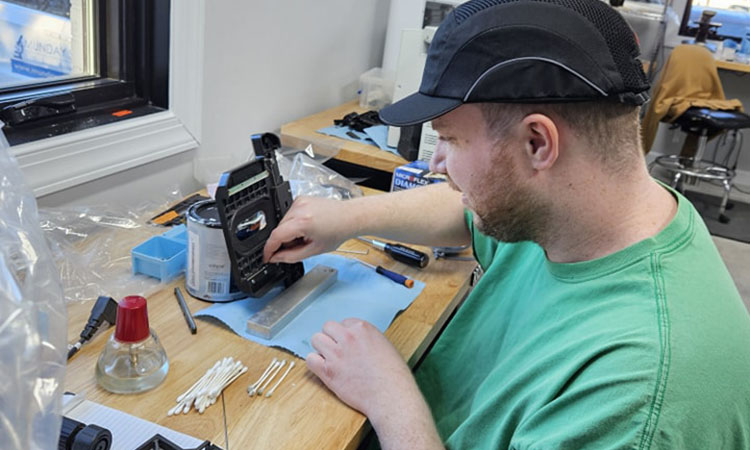 Michael doing maintenance on a microscope part